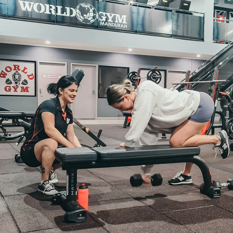 Trainer training client on bent over rows